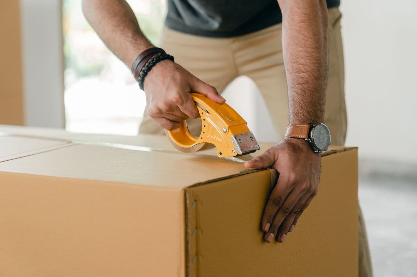 A parcel being securely packed for delivery